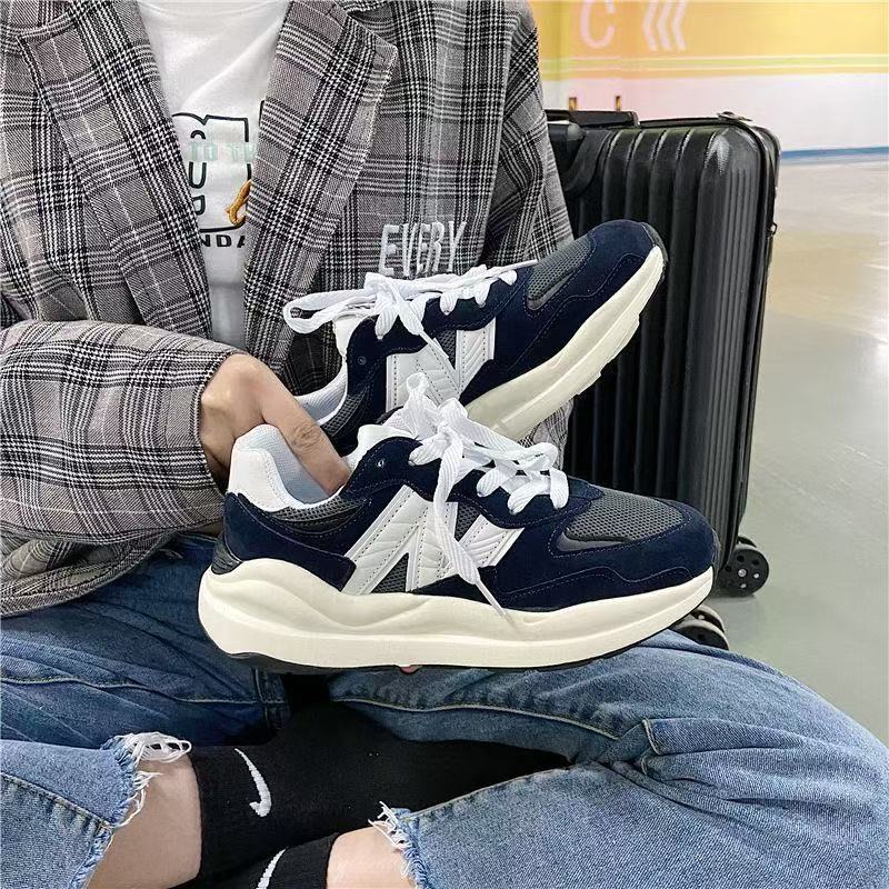Ape Shark Grey Casual Shoes chunky lace up sneakers in navy and white held by seated person with suitcase