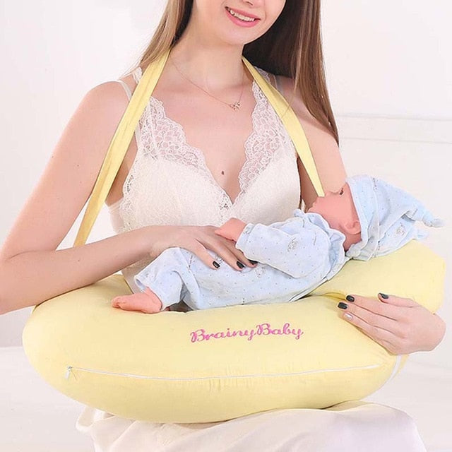 Multifunctional Nursing Pillow yellow cushion with shoulder straps supporting newborn feeding and breastfeeding