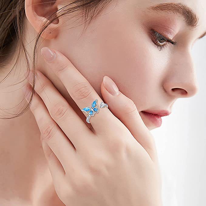 Rotatable Butterfly Ring For Women silver ring with blue crystal wings worn on model hand elegant everyday jewellery