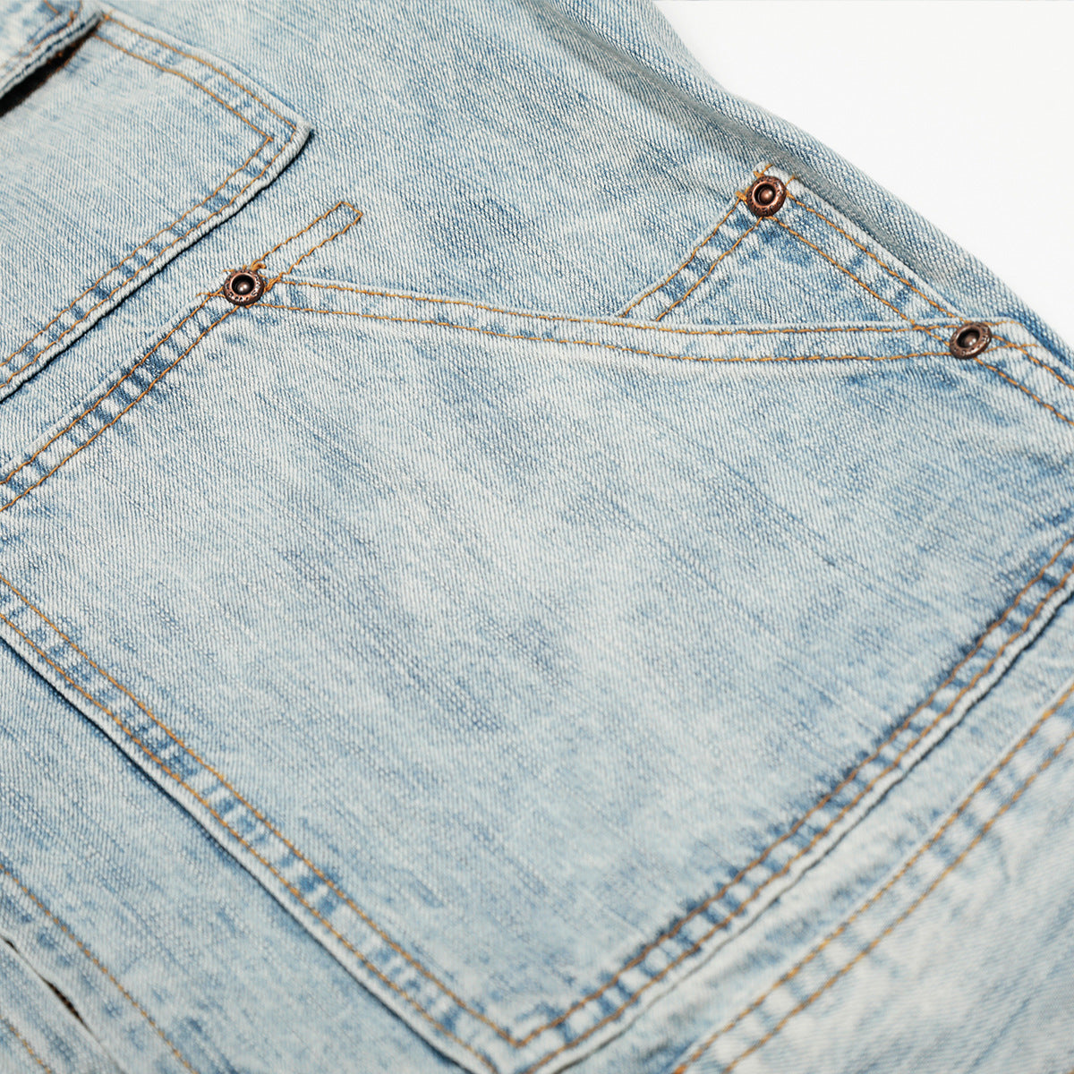 Retro washed denim jacket light blue back pocket close up with contrast stitching and metal rivets