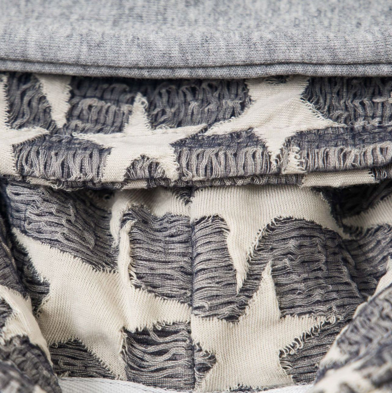 Retro Cross Rhinestone Hoodie close up of grey cream frayed cross pattern textured inner hood fabric