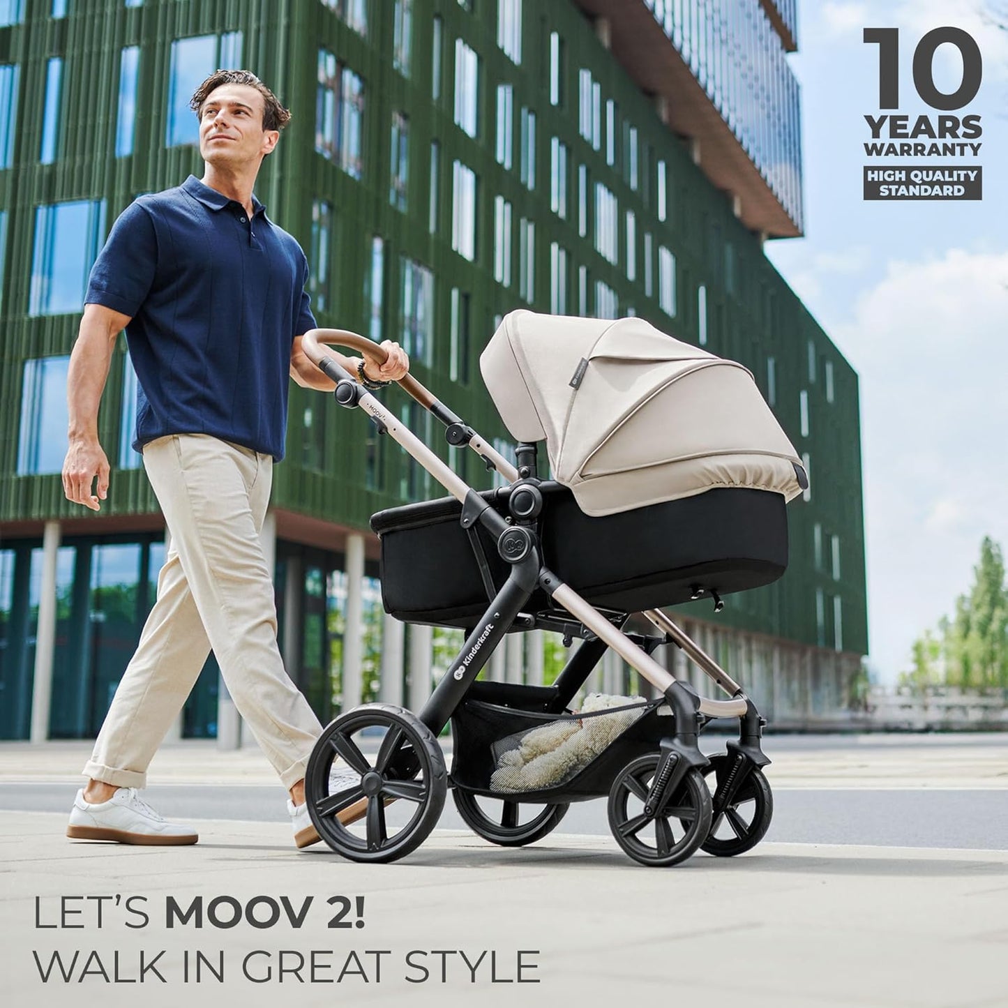 Man walking in city pushing Kinderkraft MOOV2 AIR pram set beige with modern building backdrop and 10 year warranty