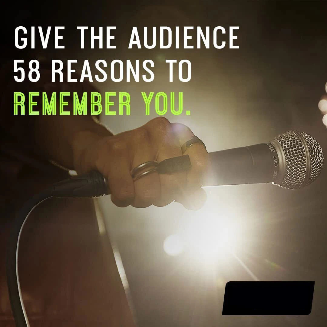 Handheld SM58 dynamic vocal microphone gripped by singer on stage with bright backlight and live performance vibe