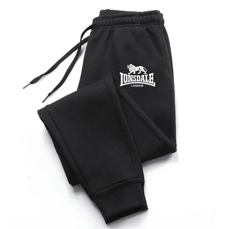 Black Lonsdale London sweatpants folded showing logo on pocket for streetwear tracksuits mens