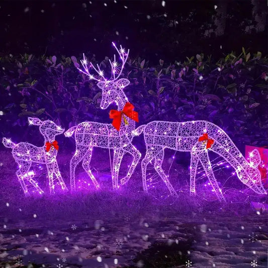 Outdoor glowing elk Christmas ornament in a festive display with lights and bows