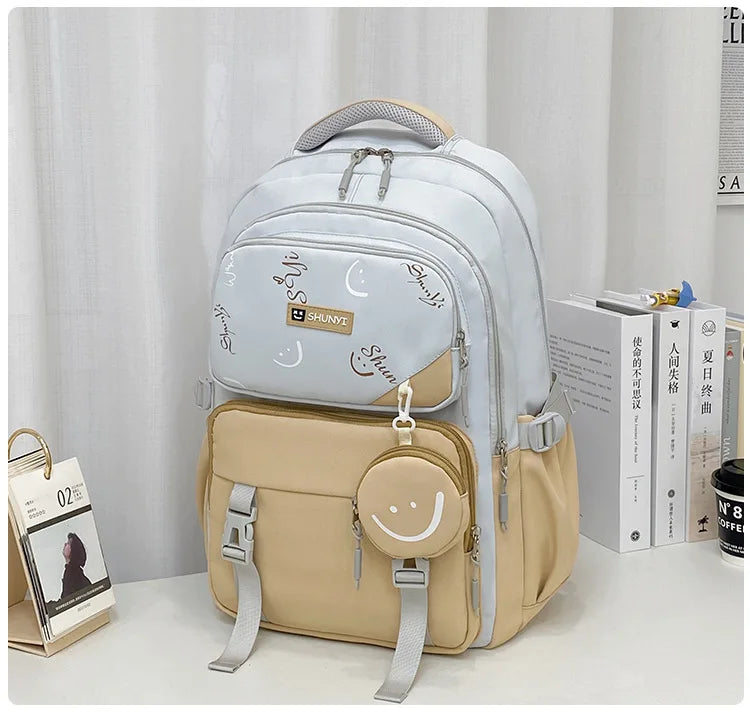 Luxurymania24 light blue and beige primary school backpack for girls with multiple pockets padded straps and smiley coin pouch