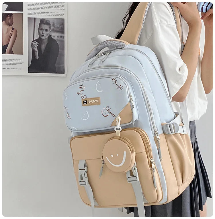 Light blue and beige ergonomic primary school backpack for girls with padded straps multiple pockets and smile pouch