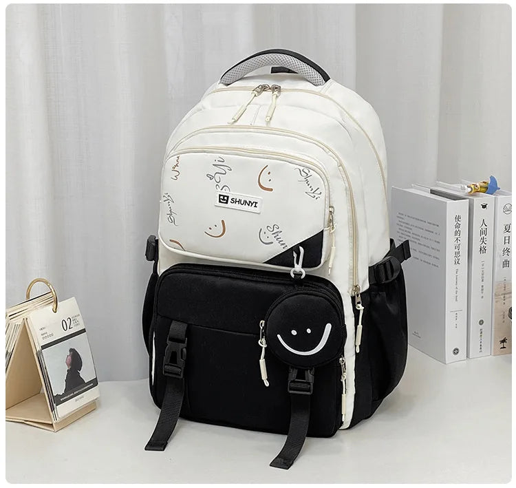 Luxurymania24 white and black smiley print primary school backpack for girls with multiple compartments and adjustable straps