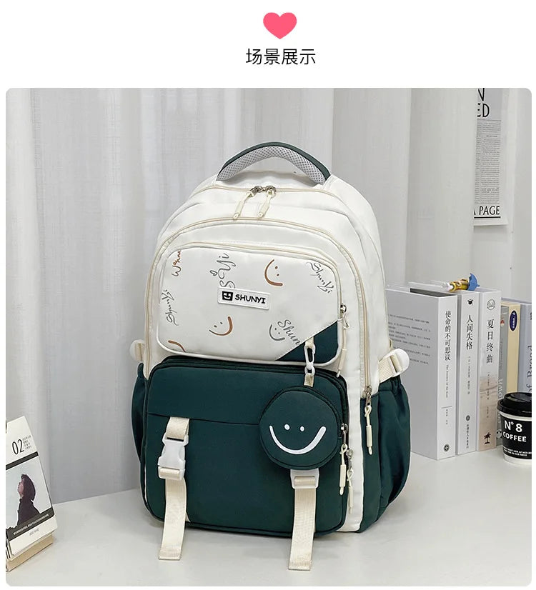 Two tone white and dark green primary school backpack for girls with multiple zip pockets and smiley coin pouch