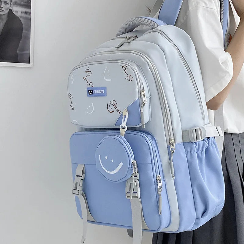 Luxurymania24 pastel blue primary school backpack for girls with multiple compartments smiley pouch