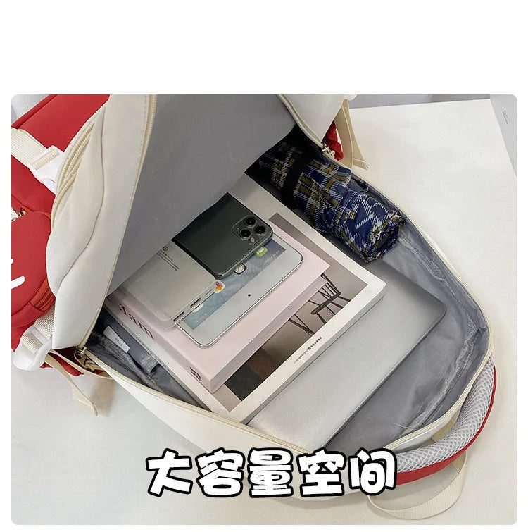 Cream and red school bag open showing tablet phone books pencil case primary school backpack for girls