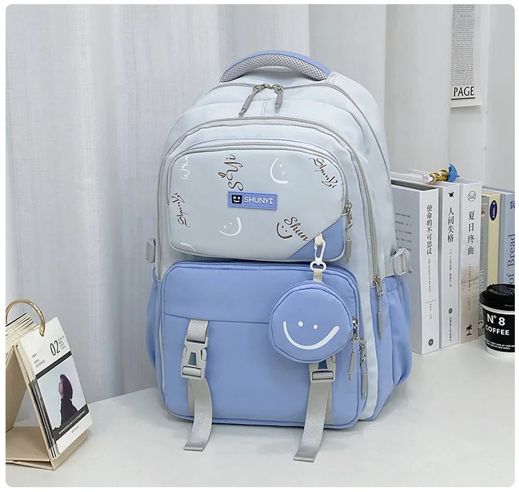 Light blue and white school bag with smiley pouch and multiple pockets ideal primary school backpack for girls
