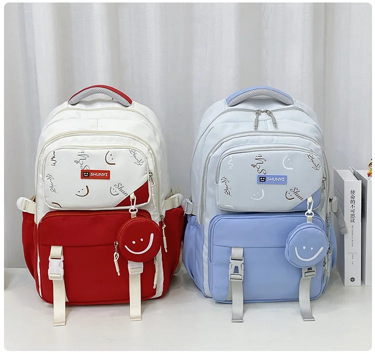 Two padded primary school backpack for girls in red and blue with moon print front pockets