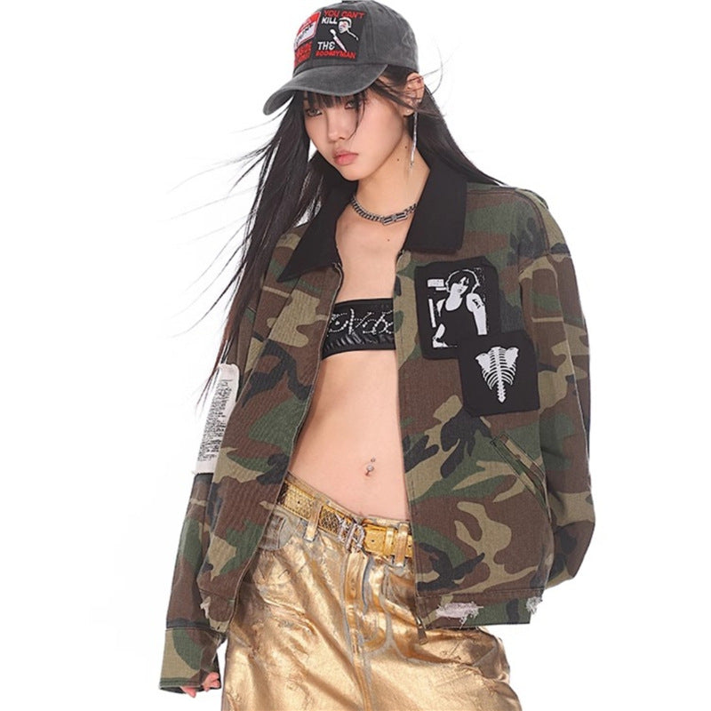 Loose Fit Workwear Jacket For Women camo jacket with black collar and graphic patches model wearing gold trousers and cap