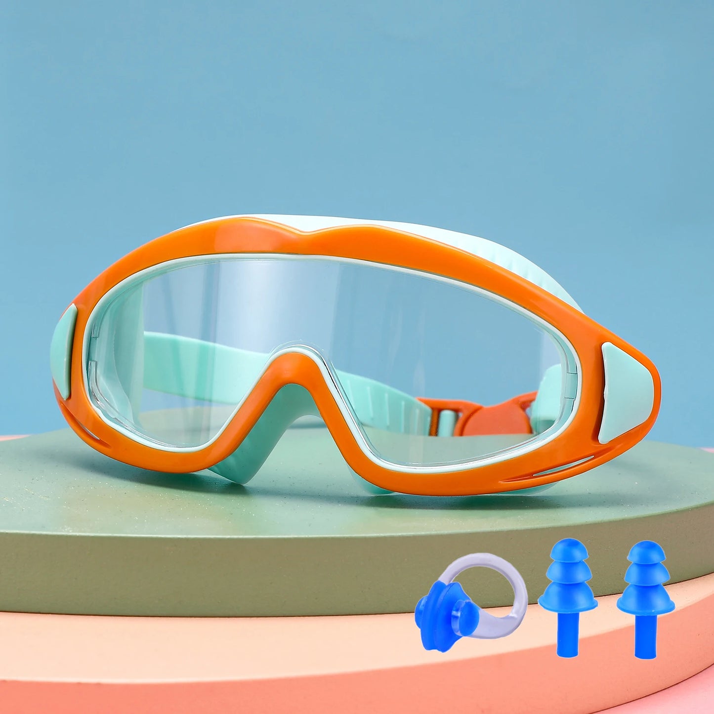 Orange and mint UV protection kids pool goggles with clear lenses and included blue earplugs and nose clip