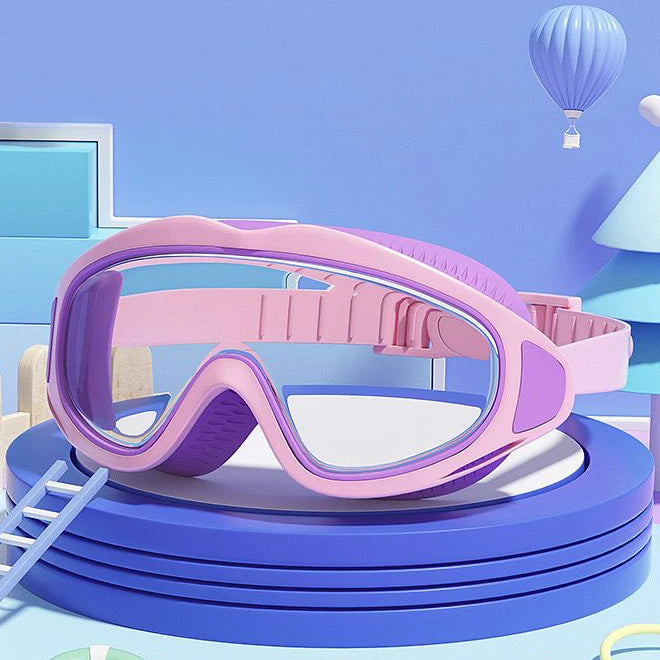 Pink UV protection kids pool goggles with adjustable strap displayed on blue circular platform
