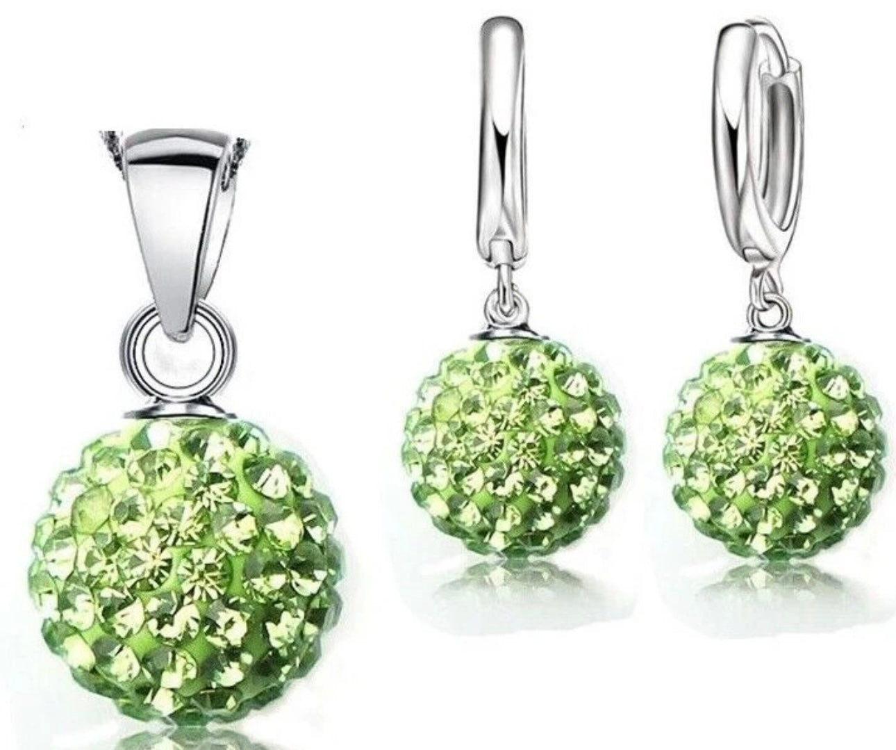 Silver jewelry set with green spherical stones on a white background