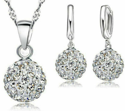 Silver jewelry set with pendant and earrings on a white background