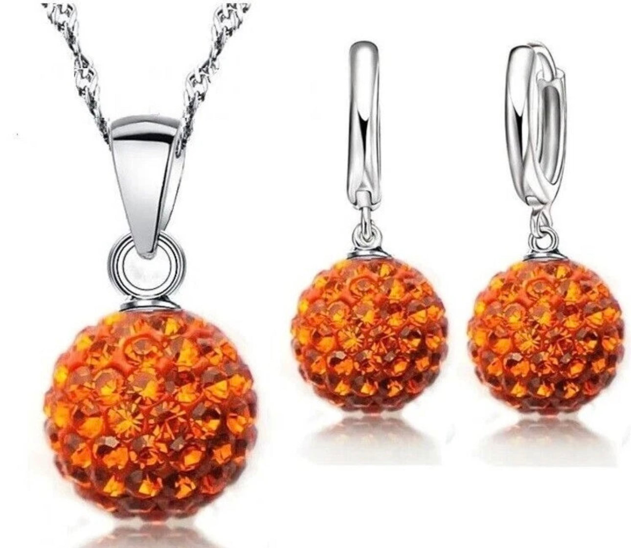 Jewelry set with orange spherical pendants on a white background