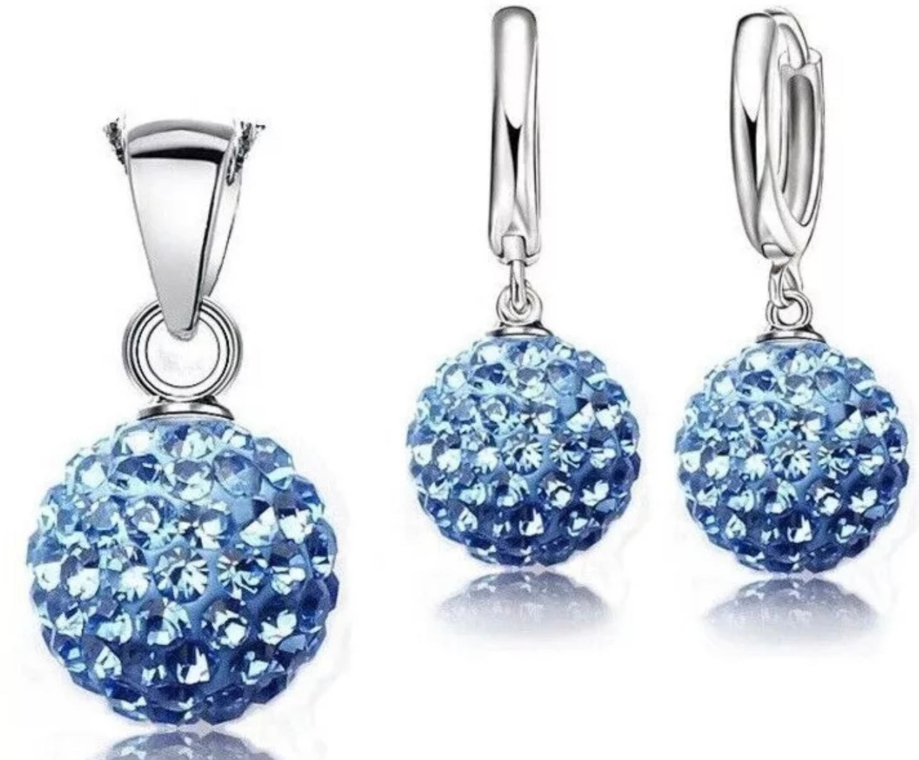 Silver jewelry set with blue spherical gemstones on a white background