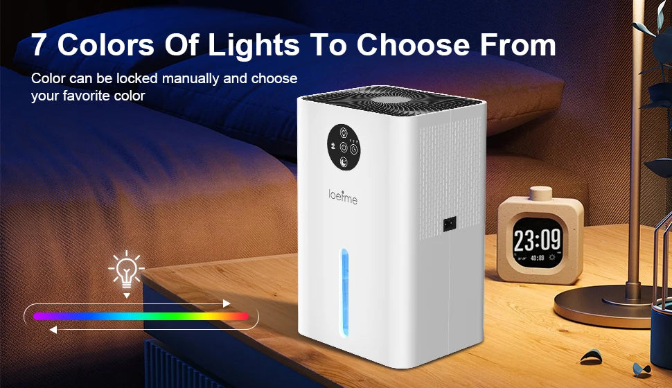 White electronic device with color selection feature on a wooden surface, surrounded by a cozy room setting.