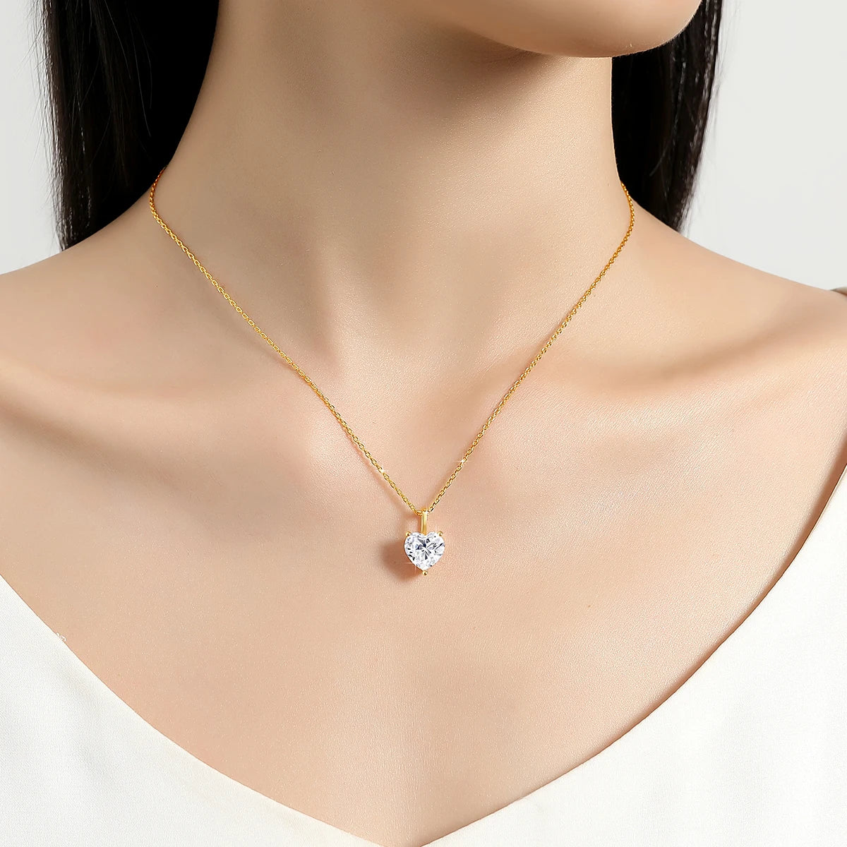 Gold necklace with a heart-shaped pendant on a mannequin