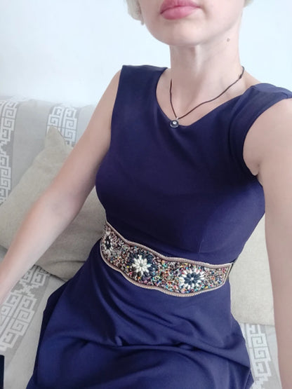Woman in navy dress wearing boho flower waist belt for women embroidered with multicolour beads and floral motifs