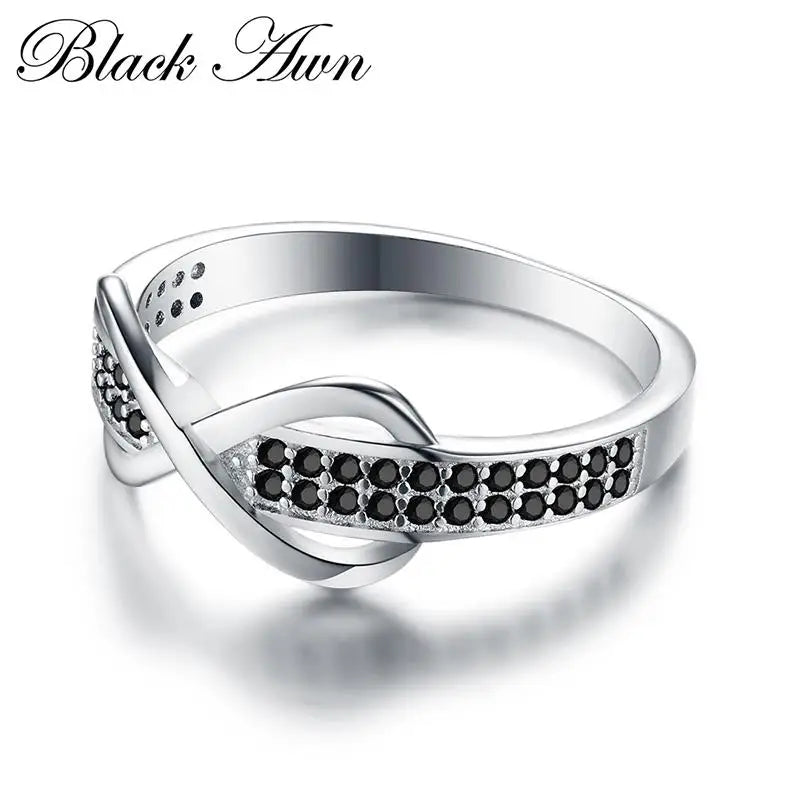 Elegant silver engagement ring for women featuring black crystal accents and a twist design