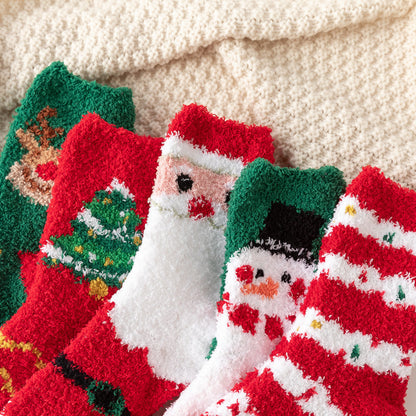 Festive fuzzy Christmas socks with Santa snowman tree and reindeer designs on a cream blanket thick winter home socks for children