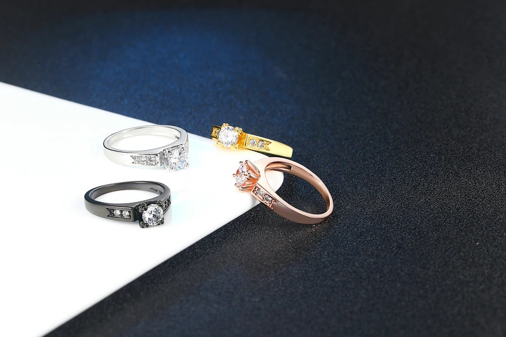 Four elegant cubic zirconia wedding rings for women in various finishes including silver and gold