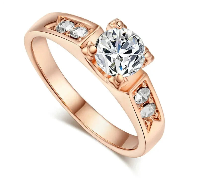 Cubic zirconia wedding ring for women with a large central stone and three side stones in a rose gold setting