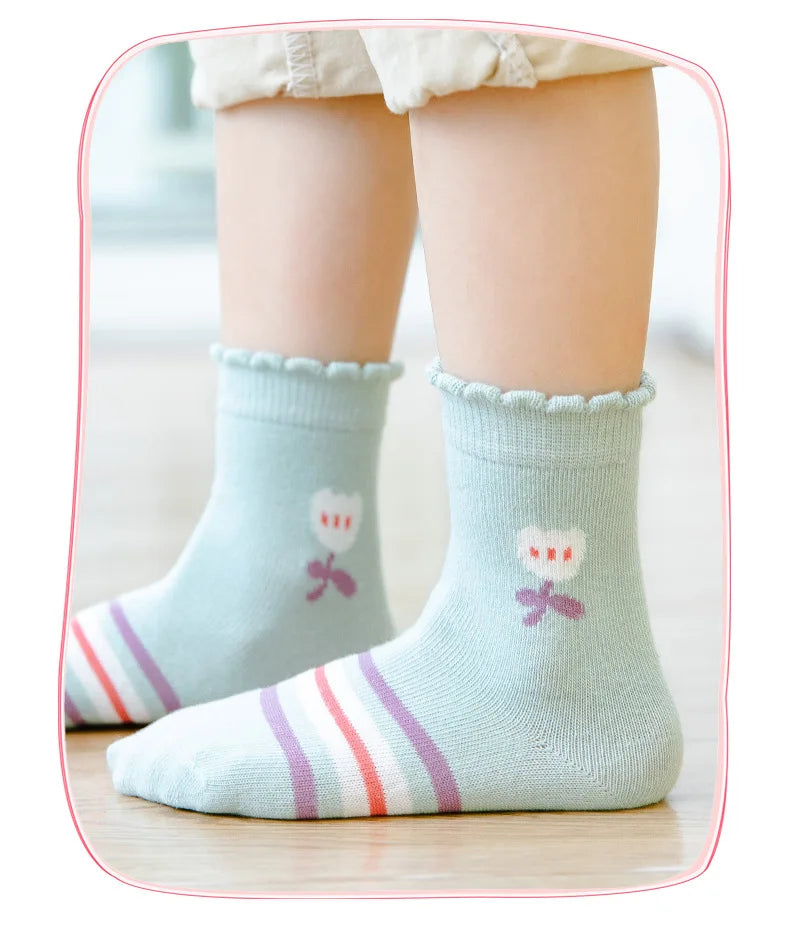 Cute kids warm socks for winter in light blue with flower design and pastel stripes
