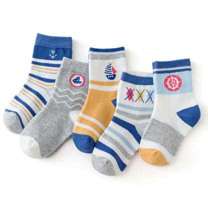 Five pairs of cute kids warm socks for winter in various colours and playful patterns