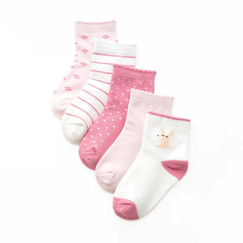Set of five cute kids warm socks for winter in pink shades with various patterns and designs