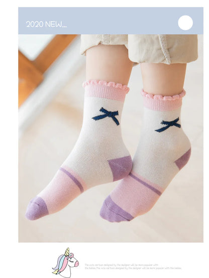 Cute kids warm socks for winter featuring a pink frill and bow design, perfect for chilly days