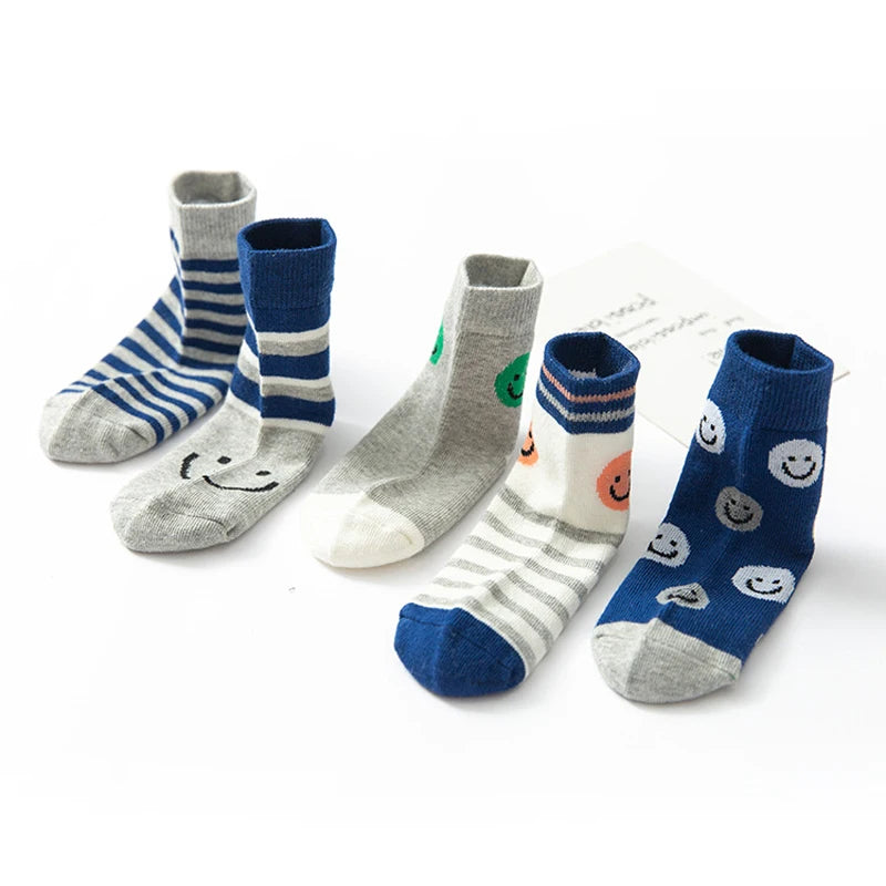 Set of cute kids warm socks for winter in cheerful patterns and colours for comfort and style