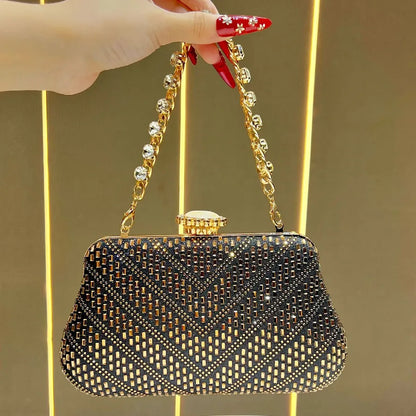 Elegant designer handheld shoulder bag UK in black with gold chain and intricate pattern