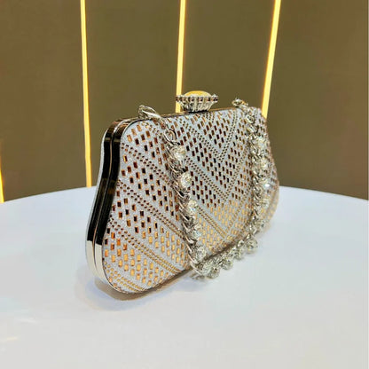 Elegant designer handheld shoulder bag UK with intricate detailing and a chic metallic finish