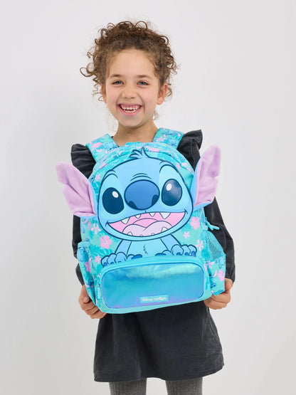 Smiling girl wearing a turquoise character backpack with plush ears Smiggle school bag set for girls.