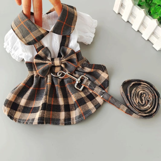 Plaid dog dress with leash for small dogs, featuring a bow and adjustable straps