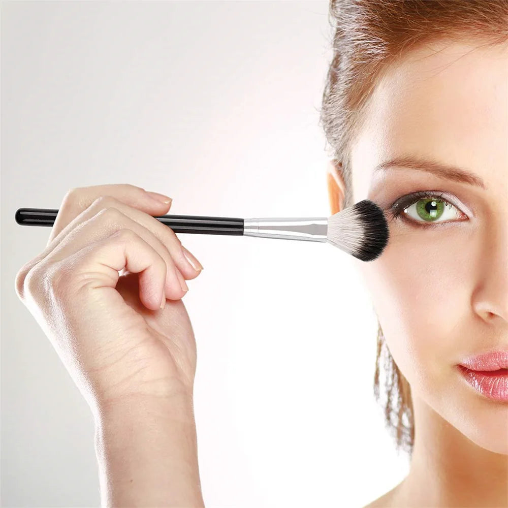 DUcare highlighter brush in use, applying shimmer to the cheekbone for a radiant glow