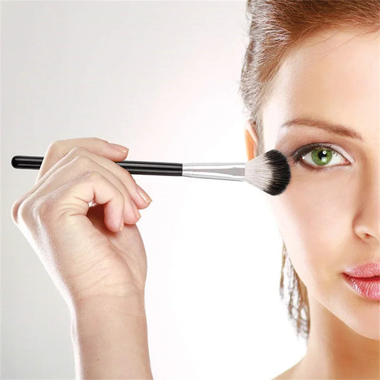 Woman applying makeup using the DUcare highlighter brush for a flawless glow