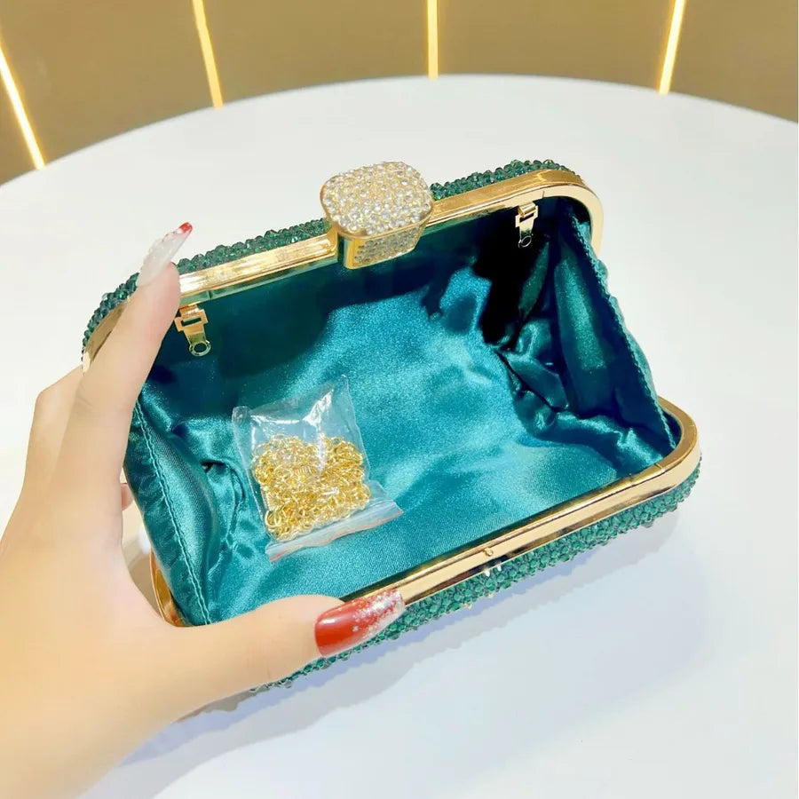 Open emerald rhinestone party handbag with gold accents and satin interior for special occasions