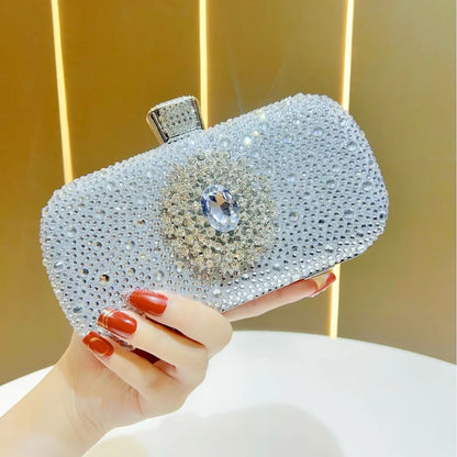 Shiny silver handbag adorned with rhinestones, ideal for parties as an emerald rhinestone party handbag