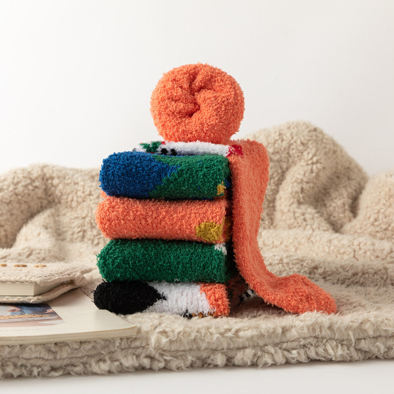 eprolo Coral Fleece Christmas Socks stacked in orange green and blue on a soft beige fleece blanket cosy