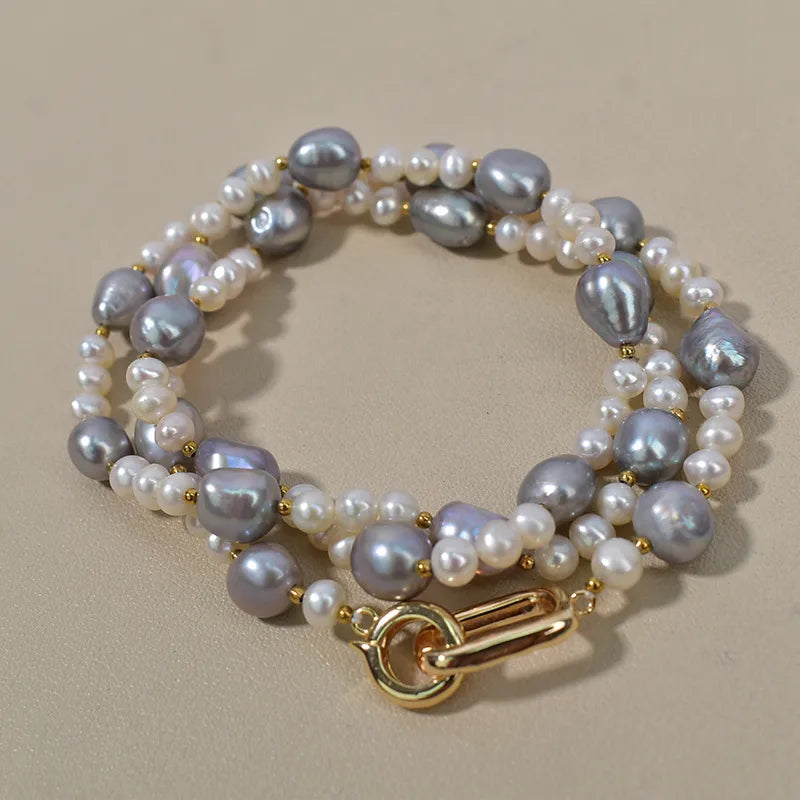 Handmade freshwater pearl necklace for women featuring grey and white pearls with a gold clasp