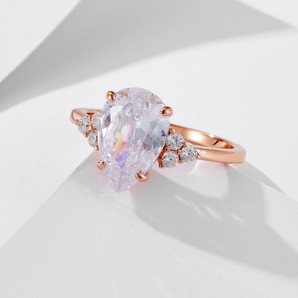 VVS1 Moissanite Ring For Women pear drop solitaire in rose gold with side diamonds by Luxurymania24