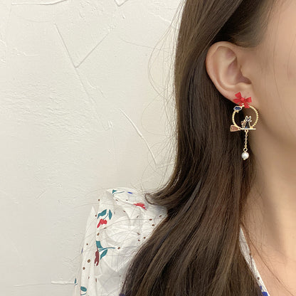 Creative Drip Oil Bow Earrings worn on ear gold hoop with red bow charm cat detail and dangling pearl