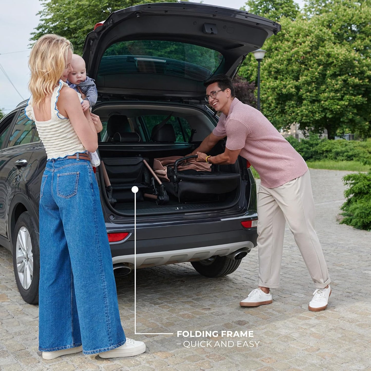 Father folds Kinderkraft MOOV2 AIR pram set into car boot while mother holds baby outdoors