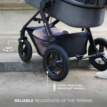 Black Kinderkraft MOOV2 AIR pram set showing large puncture resistant wheels and underseat basket with blanket